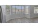 Bright living space with an open kitchen, hardwood flooring, and large windows at 10113 Plomosa Pl, Las Vegas, NV 89134