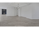 Open living room boasts fireplace feature, grey wood floors and modern lighting fixture at 10113 Plomosa Pl, Las Vegas, NV 89134