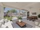 Beautiful covered patio with stylish furniture, ceiling fan, and serene backyard views at 10113 Plomosa Pl, Las Vegas, NV 89134