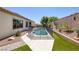 Backyard pool with safety fence and desert-style landscaping, with patio just inside at 10113 Plomosa Pl, Las Vegas, NV 89134