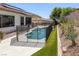 Backyard featuring a fenced pool, desert landscaping, and artificial turf at 10113 Plomosa Pl, Las Vegas, NV 89134