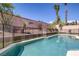 Beautiful pool with safety fence, desert landscaping, and clear water reflections at 10113 Plomosa Pl, Las Vegas, NV 89134