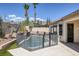Backyard pool area featuring a safety fence, desert landscaping, and desert view at 10113 Plomosa Pl, Las Vegas, NV 89134
