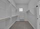 Spacious walk-in closet with shelving for optimal organization and convenient access to an attached bathroom at 10113 Plomosa Pl, Las Vegas, NV 89134
