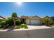 Charming single-story home boasts a well-manicured lawn, desert landscaping, and an attached two-car garage at 10645 Alpine Frost Ct, Las Vegas, NV 89129