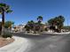Gated community entrance featuring mature palm trees and manicured landscaping near the 'Monument' sign at 10645 Alpine Frost Ct, Las Vegas, NV 89129
