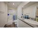 Bathroom featuring a walk-in shower with glass doors, granite countertop vanity, and white cabinets at 1131 Ruby Sparrow St, Henderson, NV 89011