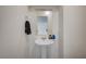 Clean and modern half bathroom featuring a pedestal sink and mirror at 1131 Ruby Sparrow St, Henderson, NV 89011