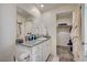 Bathroom with granite countertop, vanity, and a view of the walk-in closet at 1131 Ruby Sparrow St, Henderson, NV 89011
