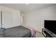 Carpeted bedroom with a closet, TV and neutral walls at 1131 Ruby Sparrow St, Henderson, NV 89011