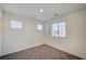 Light-filled bedroom featuring neutral carpeting and multiple windows for ample natural light at 1131 Ruby Sparrow St, Henderson, NV 89011