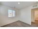 Bright bedroom with neutral carpet, large window, and ensuite bathroom access at 1131 Ruby Sparrow St, Henderson, NV 89011