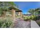 Community area with a shaded pergola, stone pillars, and picturesque landscaping at 1131 Ruby Sparrow St, Henderson, NV 89011