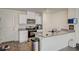 Bright kitchen features white cabinets, stainless steel appliances, and granite countertops at 1131 Ruby Sparrow St, Henderson, NV 89011