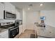 Well-lit kitchen with stainless steel appliances and a granite countertop island at 1131 Ruby Sparrow St, Henderson, NV 89011