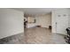 Bright living room with gray wood floors and an open layout leading to the kitchen at 1131 Ruby Sparrow St, Henderson, NV 89011