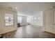 Bright, open living room featuring large windows and modern, gray wood-look flooring at 1131 Ruby Sparrow St, Henderson, NV 89011