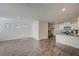 Open concept living room with a view of the kitchen featuring white cabinets and countertops at 1131 Ruby Sparrow St, Henderson, NV 89011