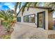 Backyard featuring a concrete patio, desert landscaping, palm trees and a sliding door at 11441 Drappo Ave, Las Vegas, NV 89138