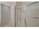 Bathroom showcasing a shower and bathtub combination, tile floors, and a white door at 11441 Drappo Ave, Las Vegas, NV 89138