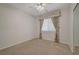 Cozy bedroom with a ceiling fan and a large window with custom drapes at 11441 Drappo Ave, Las Vegas, NV 89138