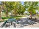 A serene community park featuring picnic tables, walking paths, and shaded areas under mature trees at 11441 Drappo Ave, Las Vegas, NV 89138