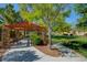 Inviting community park featuring a covered seating area, mature trees, and manicured landscaping, perfect for relaxation at 11441 Drappo Ave, Las Vegas, NV 89138