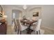 Formal dining area featuring a decorative chandelier, stylish table, and neutral-toned chairs at 11441 Drappo Ave, Las Vegas, NV 89138