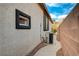 Exterior home view with small window, an AC unit, and walkway on the side of the house at 11441 Drappo Ave, Las Vegas, NV 89138