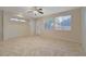 Spacious living room features tile flooring, ceiling fan, and large windows, providing an airy and bright space at 11441 Drappo Ave, Las Vegas, NV 89138