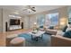 Bright living room with hardwood floors, plush seating, ceiling fan, and large windows at 11441 Drappo Ave, Las Vegas, NV 89138