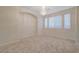 Spacious living area with tiled floors, chandelier, and ample natural light at 11441 Drappo Ave, Las Vegas, NV 89138