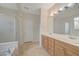 Bright main bathroom with a double vanity sink, shower, and soaking tub at 11441 Drappo Ave, Las Vegas, NV 89138