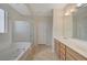 Bright bathroom with double sink vanity, soaking tub, and enclosed shower at 11441 Drappo Ave, Las Vegas, NV 89138