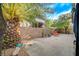 Well-maintained patio features a relaxing lounge chair and mature trees offering shade and privacy at 11441 Drappo Ave, Las Vegas, NV 89138