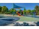 Vibrant community playground with a variety of colorful play structures and a shaded area, ensuring hours of fun at 11441 Drappo Ave, Las Vegas, NV 89138