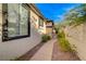 A secluded walkway with manicured landscaping, adding privacy to the home at 11441 Drappo Ave, Las Vegas, NV 89138