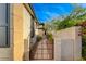 Private side yard showcasing a gated walkway and well maintained landscape at 11441 Drappo Ave, Las Vegas, NV 89138