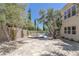 Spacious backyard with a pool, mature landscaping, and a stone patio, creating a private oasis at 11550 Lampeter Ct, Las Vegas, NV 89138
