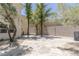Expansive backyard featuring a stone patio area and mature landscaping, ideal for outdoor living at 11550 Lampeter Ct, Las Vegas, NV 89138