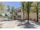 Wide shot of the backyard featuring a pool, patio, and mature trees surrounding the property at 11550 Lampeter Ct, Las Vegas, NV 89138
