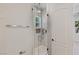 Modern glass enclosed shower with rainfall showerhead and designer tile at 11550 Lampeter Ct, Las Vegas, NV 89138