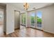 Bright bedroom featuring double doors to a balcony, hardwood floors, and stylish lighting at 11550 Lampeter Ct, Las Vegas, NV 89138