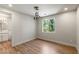 Bright bedroom with modern lighting fixture and views of lush outdoor landscaping at 11550 Lampeter Ct, Las Vegas, NV 89138