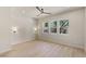 Spacious bedroom with wood flooring, multiple windows, and a ceiling fan at 11550 Lampeter Ct, Las Vegas, NV 89138