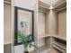 Custom closet design featuring ample shelving and hanging space, enhanced by a decorative mirror at 11550 Lampeter Ct, Las Vegas, NV 89138