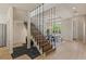 Elegant dining room with modern staircase, chandelier, and views of the front entrance at 11550 Lampeter Ct, Las Vegas, NV 89138