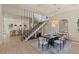 Bright dining area featuring a unique staircase design and modern light fixture at 11550 Lampeter Ct, Las Vegas, NV 89138