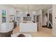 Bright kitchen boasts white cabinetry, stainless steel appliances, and a large center island with barstool seating at 11550 Lampeter Ct, Las Vegas, NV 89138