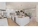 Spacious kitchen with a center island, stainless steel appliances, and a staircase in the background at 11550 Lampeter Ct, Las Vegas, NV 89138
